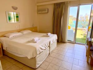 Ένα ή περισσότερα κρεβάτια σε δωμάτιο στο New Aegli Resort Hotel