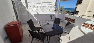 a patio with a table and chairs on a balcony at Vinaros Beach in Vinarós