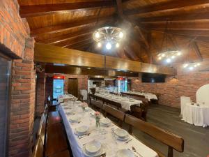 a dining room with tables and chairs in a building at Apartments Sweet Home in Otočac