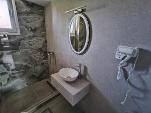 a bathroom with a sink and a mirror at Irina's Apartment 4 in Psakoudia +35 photos