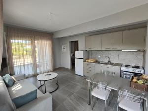a kitchen and living room with a couch and a table at Irina's Apartment 4 in Psakoudia