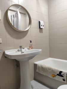 a bathroom with a sink and a mirror and a tub at La Huerta del Parral in Soportújar