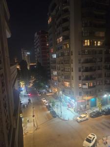 a city at night with cars parked in a parking lot at Apartament in Mekhrably