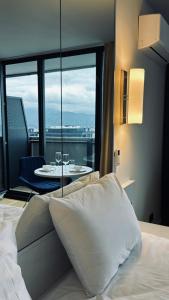 a bedroom with a bed and a table with a view at BEST VIEW APARTMENTS ORBI CITY D1 BLOCk in Batumi