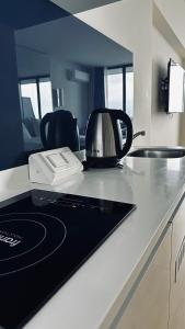 a microwave sitting on a counter in a kitchen at BEST VIEW APARTMENTS ORBI CITY D1 BLOCk in Batumi