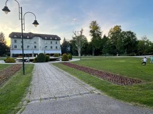 a large white building in the middle of a park at Aurum Modern in Sarajevo