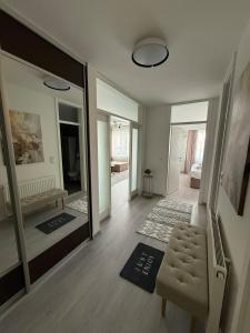 a living room with a mirror and a chair at Aurum Modern in Sarajevo