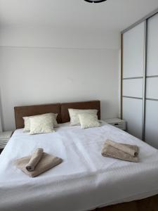 a bedroom with a bed with two towels on it at Aurum Modern in Sarajevo +14 photos