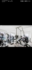 a gym with several cardio bikes and tread machines at Meraki Resort & Spa Isabellae Home in Mamaia Nord +50 photos