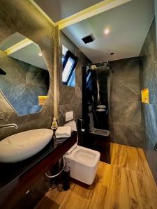 a bathroom with a sink and a toilet at Empire of Martin in Gjirokastër