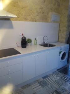 a kitchen with a sink and a washing machine at San Roque Apartment in Alicante