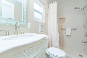 a bathroom with a sink and a toilet and a shower at Cozy Family Beach Home Half Block To Popular 44Th St Beach By Beachview Rentals in Newport Beach +21 photos