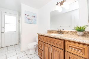 a bathroom with a sink and a toilet at Spacious 4Br W Oceanview Balcony & Bbq Steps To Sand By Beachview Rentals in Newport Beach +24 photos