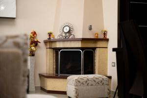 a living room with a fireplace and a chair at Doel's Villa in Gjirokastër