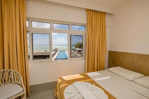Postel nebo postele na pokoji v ubytování Yak Beach Hotel Natal