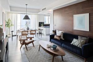 a living room with a couch and a dining room at 9+Ocho Suites by Yellowkey in Santo Domingo