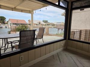 a screened in porch with a table and chairs at Chic Lake House 3 bedroom in Helendale