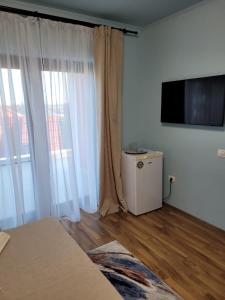 a living room with a television and a room with white walls at Kys House in Techirghiol