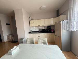 a kitchen with a table and chairs and a refrigerator at Central apt II in Sunny town in Ulaanbaatar