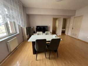 a dining room with a white table and chairs at Central apt II in Sunny town in Ulaanbaatar