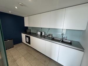 a kitchen with white cabinets and a counter top at 5 Brewhouse by Pureserviced in Plymouth