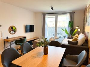 a living room with a table and a couch at Cozy & Modern 2 BR Apartment in peaceful Area in Vienna
