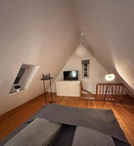 a living room with a couch and a tv at Gemütliche Maisonettenwohnung in Dannenberg Elbe in Dannenberg