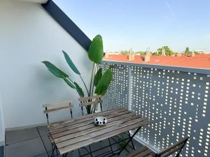 a wooden table with a soccer ball sitting on a balcony at Cozy & Modern 2 BR Apartment in peaceful Area in Vienna