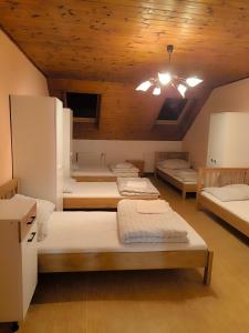 a room with four beds and a ceiling at Lydiana Ubytování in Vysoké Mýto +48 photos