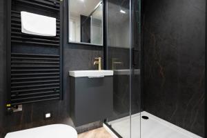 a bathroom with a toilet and a sink and a shower at Princess Street luxury apt - Portrush in Portrush