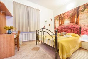 a bedroom with a bed with a painting on the wall at Oasi Verde in Castiglione Chiavarese