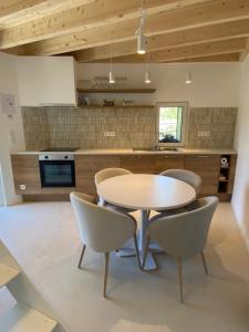 a kitchen with a table and chairs in a room at Weserwasser in Eupen