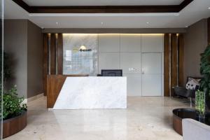 an office lobby with a white reception desk at 9+Ocho Suites by Yellowkey in Santo Domingo +93 photos