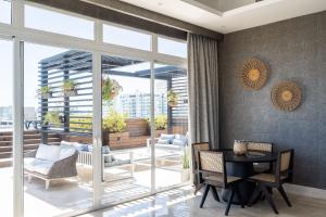 a living room with a table and chairs at 9+Ocho Suites by Yellowkey in Santo Domingo