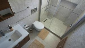 a bathroom with a shower and a toilet and a sink at Oludeniz Villa with Private Pool in Fethiye +10 photos