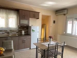a kitchen with a table and a white refrigerator at Soti's House in Kallirákhi