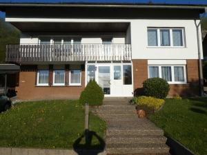 a house with a white door and a porch at FeWo Ruhe in Olsberg