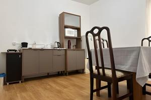 a kitchen with a table and a chair in a room at Apartment in the Center 2 in Pomerode