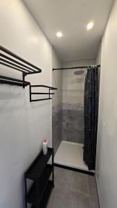 a bathroom with a shower with a bench in it at Le treport - centre - Plain-pied 1 chambre in Le Tréport