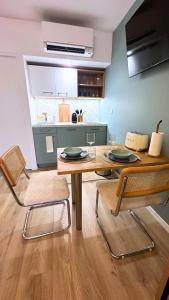 a dining room with a table and two chairs at Exotic Garden - Studio cosy hypercentre Auxerre in Auxerre