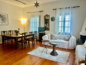 a living room with a white couch and a table at Electra Beach House in Chorefto