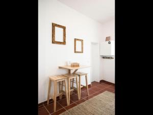 una pequeña cocina con mesa y nevera en Nooks Apartment, en Sintra