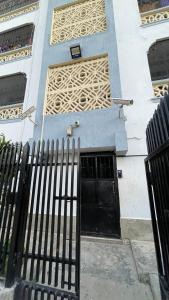 a building with two black doors and a fence at DRE'S WORLD STAYs in Mombasa