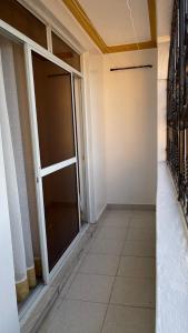 an empty room with a large sliding glass door at DRE'S WORLD STAYs in Mombasa