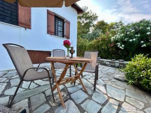 a wooden table and two chairs on a patio at Electra Beach House in Chorefto