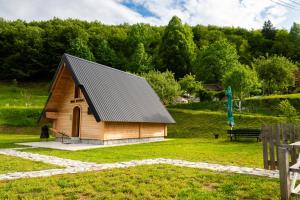 a small wooden cabin in a field with trees at Wolf's PEAK in Kolašin