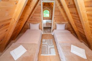 two beds in the attic of a log cabin at Wolf's PEAK in Kolašin