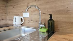 a kitchen counter with a sink and a bottle of wine at Apartments NIM in Jajce +92 photos