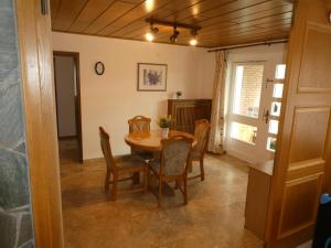 a dining room with a table and chairs at FeWo Ruhe in Olsberg