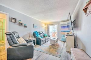 a living room with two couches and a television at North Topsail Condo - Steps to Beach! in North Topsail Beach